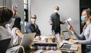 business people wearing masks in coronavirus meeting the new normal