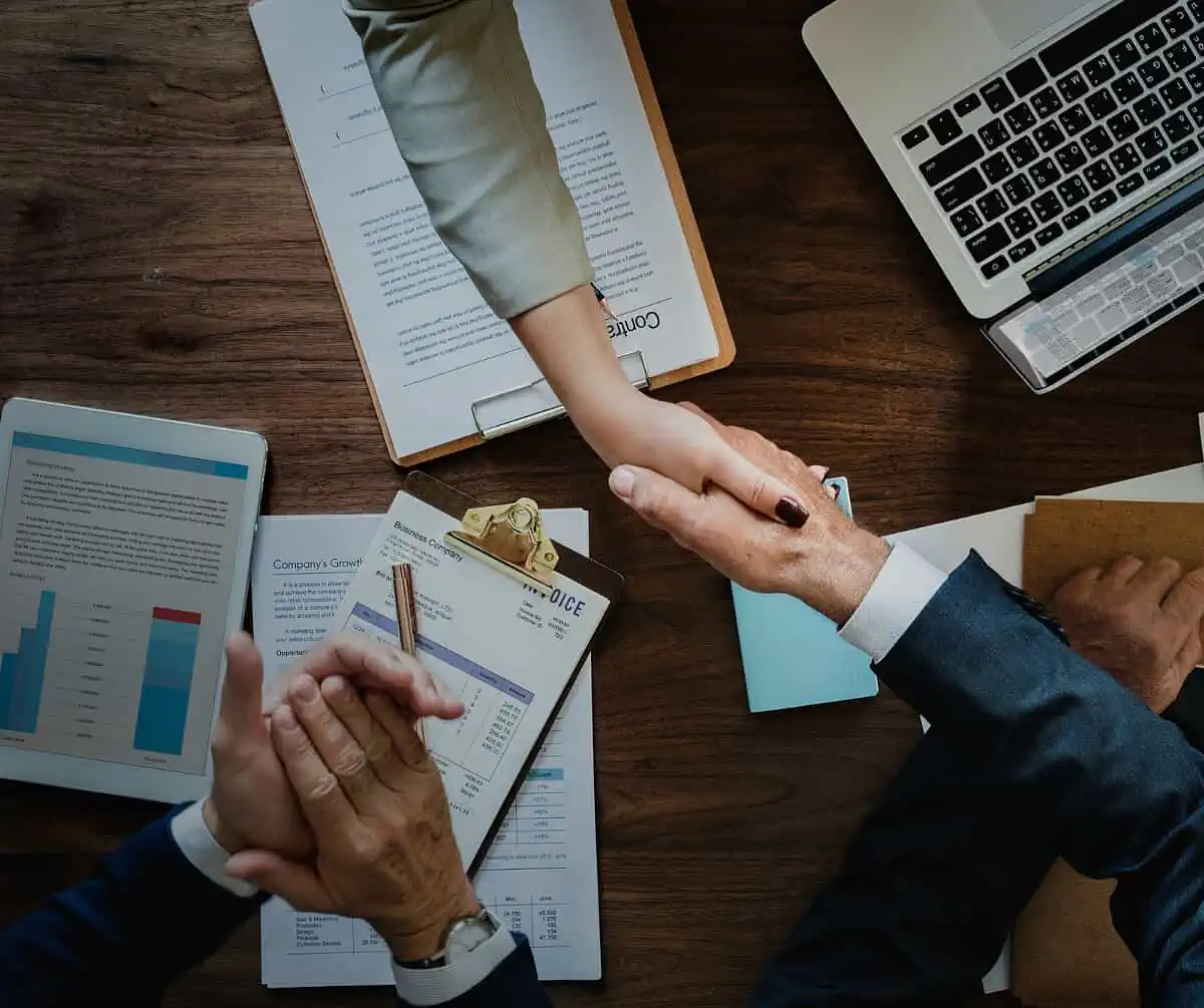 business people shaking hands together