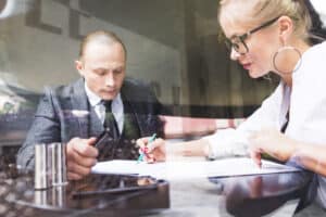 two businesspeople examining document restaurant